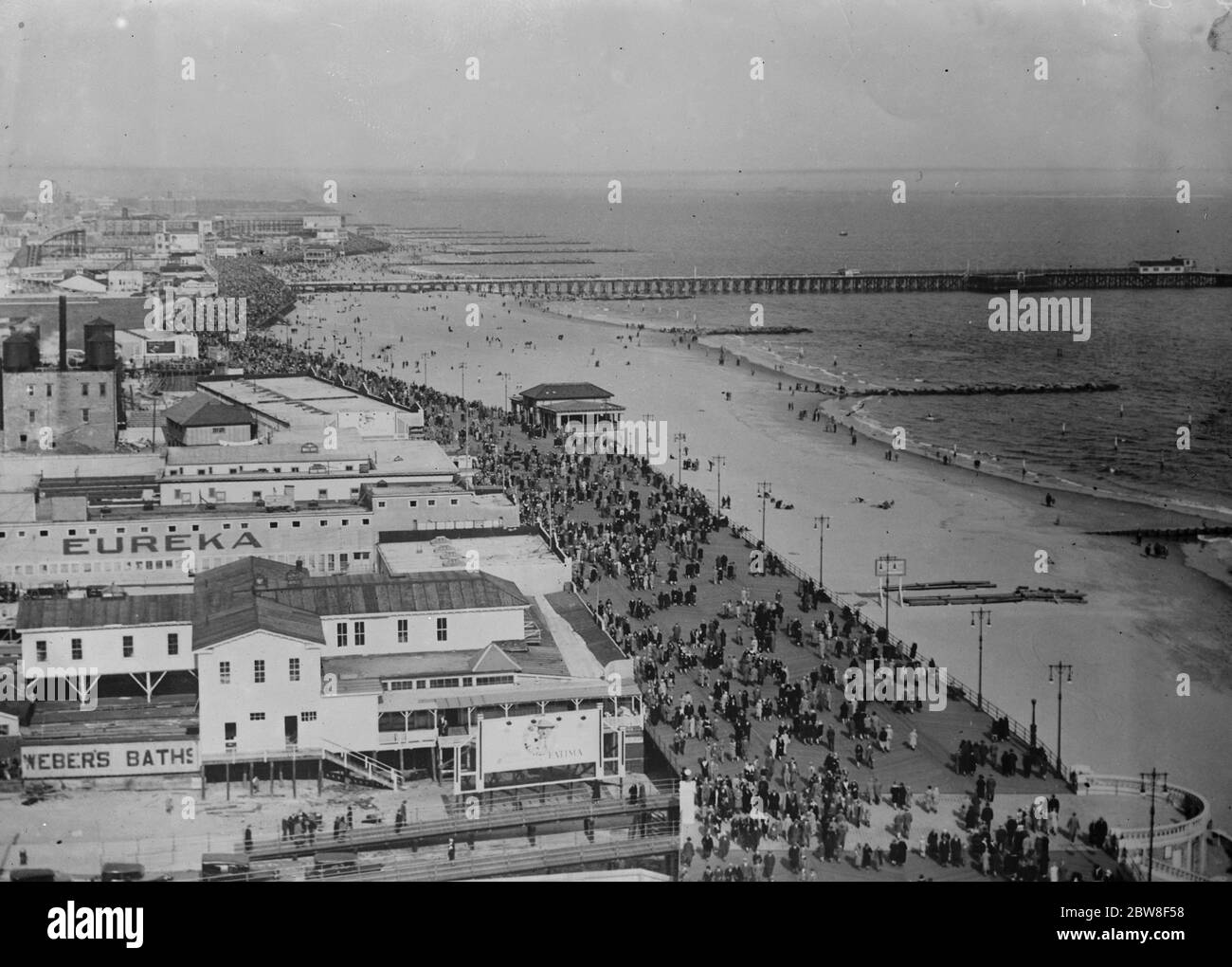 The crowded beach at Coney Island showing the famous broadwalk . 15 July 1932 Stock Photo