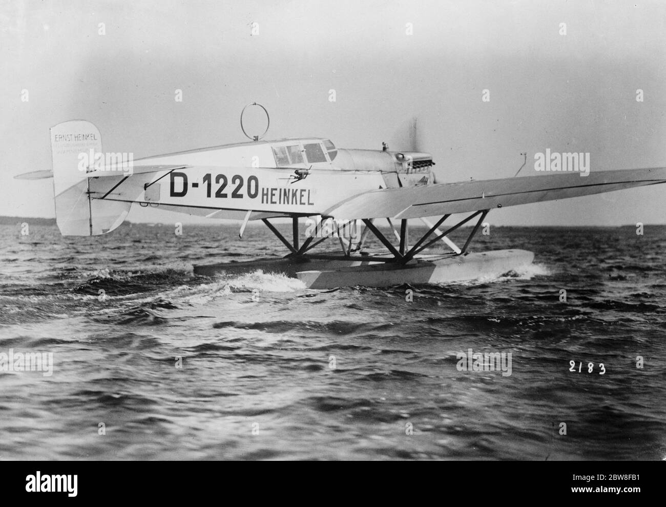 German seaplane D1220 leaves Wilhelmshaven on a transatlantic flight. The seaplane taxiing along the water . 14 October 1927 Stock Photo