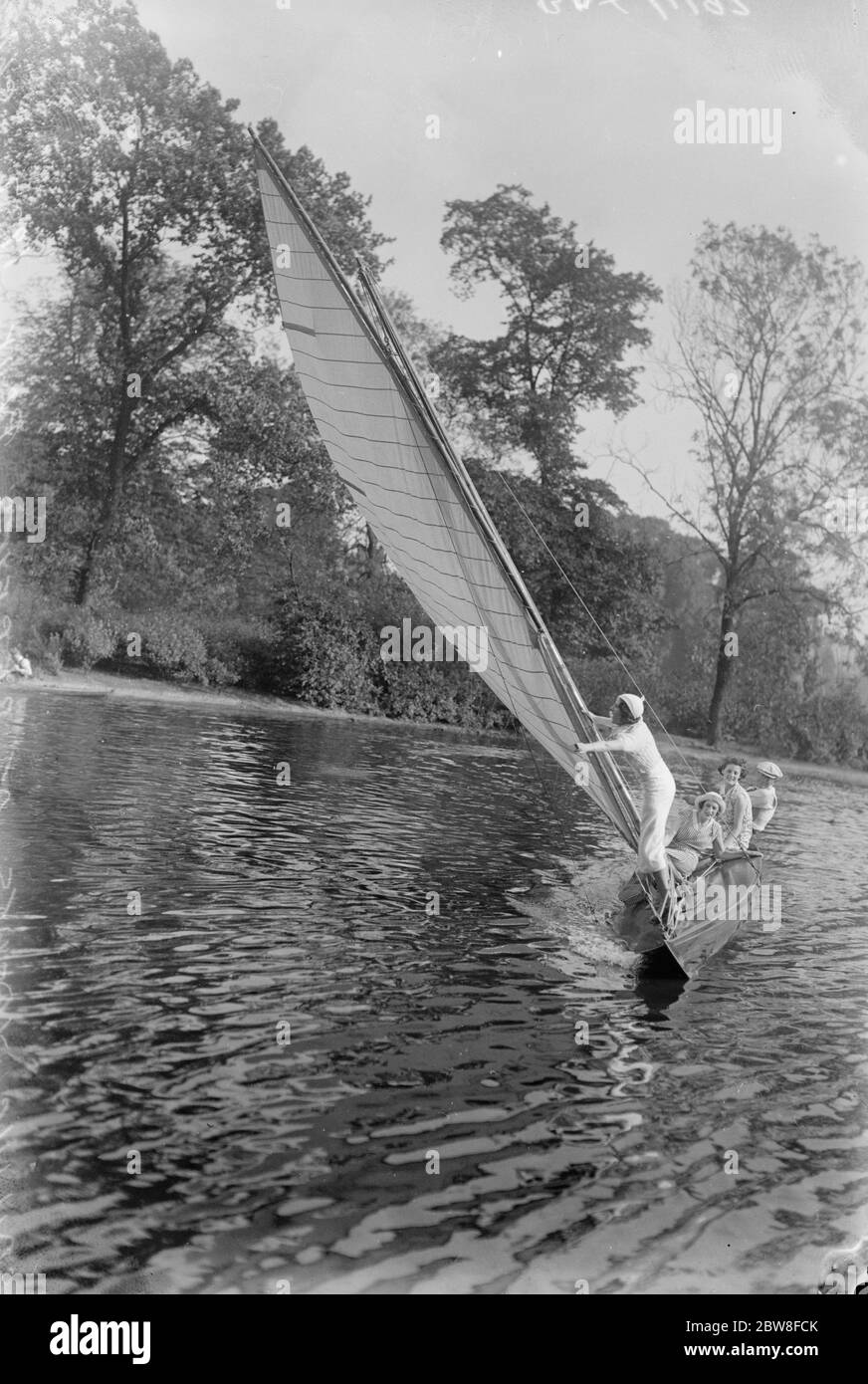 Sailing thrills in the Heart of London . Small sailing yachts have just been installed to add to the pleasures of Londoners on the lake , with its picturesque surroundings , in Regents Park . One of the yachts heeling over in a delightfully welcome breeze during the wave . 18 August 1932 Stock Photo