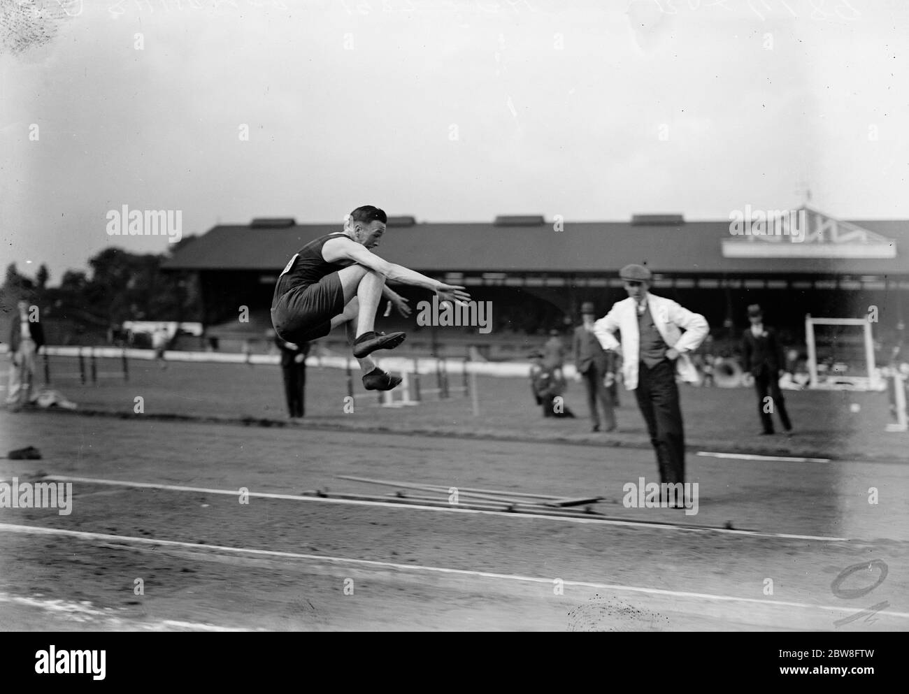 AAA Junior championship at Stamford Bridge . C A Shurmer ( Herne Hill Harriers ) wins the long jump . 25 June 1932 Stock Photo