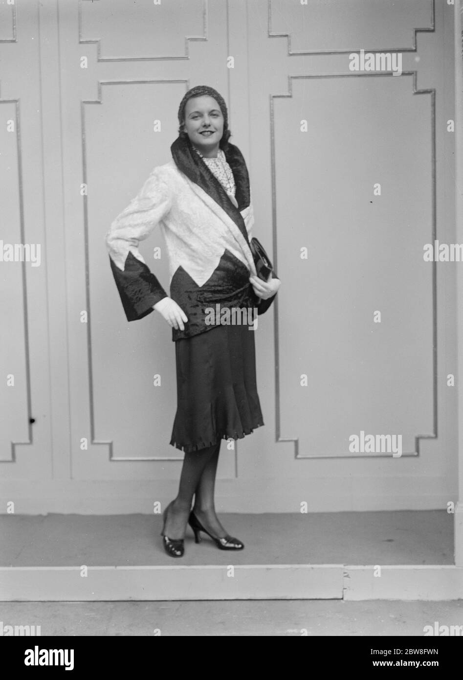 The fashion exhibition at Olympia . Miss Joan Adams , who represented England in the world beauty contest in America , wearing a short brocaded tail coat , suitable for evening wear . 28 August 1931 Stock Photo