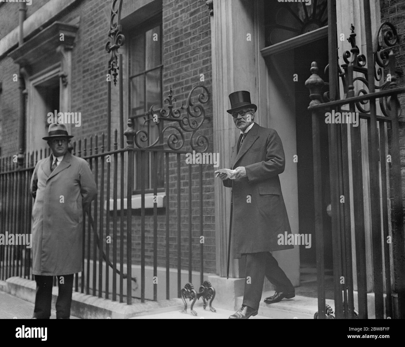 The Premier leaves to the King . Mr Ramsay Macdonald leaving No 10 , Downing street to see the King . He was wearing horn rimmed glasses . 29 September 1931 Stock Photo