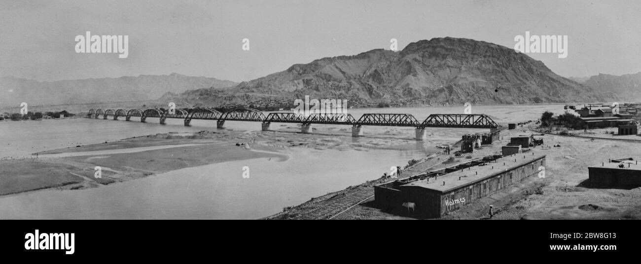 An engineering feat in India . A photograph just received in London of the New North Western Railway Bridge at Kalabagh over the Indus River . The city of Kalabagh is seen in the background . 15 August 1931 Stock Photo