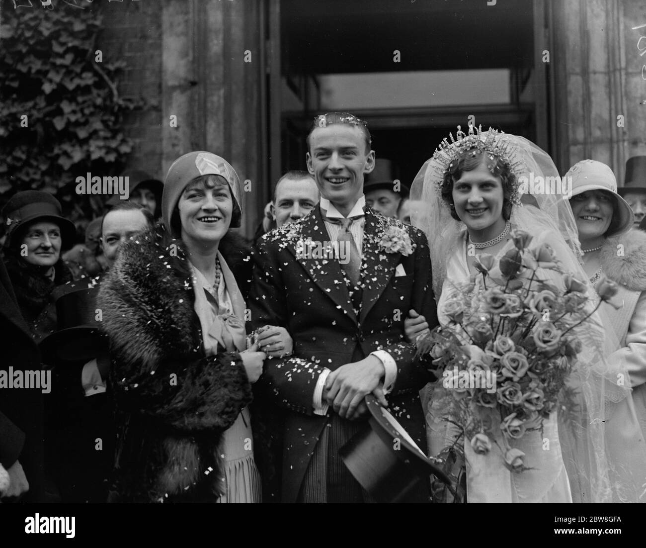 The wedding of Mr Tommy Fields , brother of Gracie Fields , at St John 's Church , Hampstead , to Miss Betty Whiteside . Bride and Groom with Gracie Fields 17 March 1930 Stock Photo