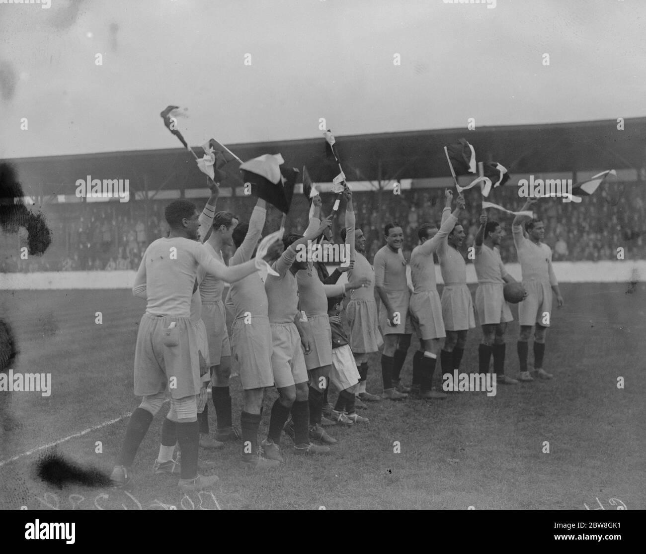Peru- Chile footballers meet West Ham United . The Peru - Chile football team played West Ham United , at Upton Park , on Monday . The team giving their ' war cry ' accompanied by flag waving . 16 October 1933 Stock Photo