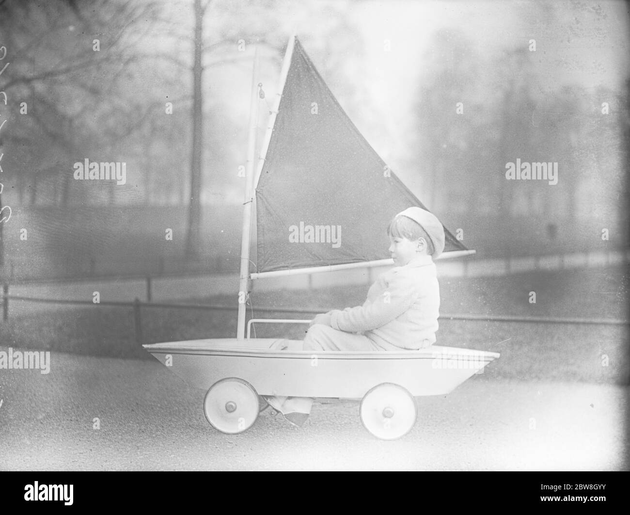 A land yacht in Hyde Park . Master Alastair Maskelyne , son of Mr Jasper Maskelyne , the well known illusionist , takes his yacht into Hyde Park for a sail stretching trial . 31 January 1933 Stock Photo