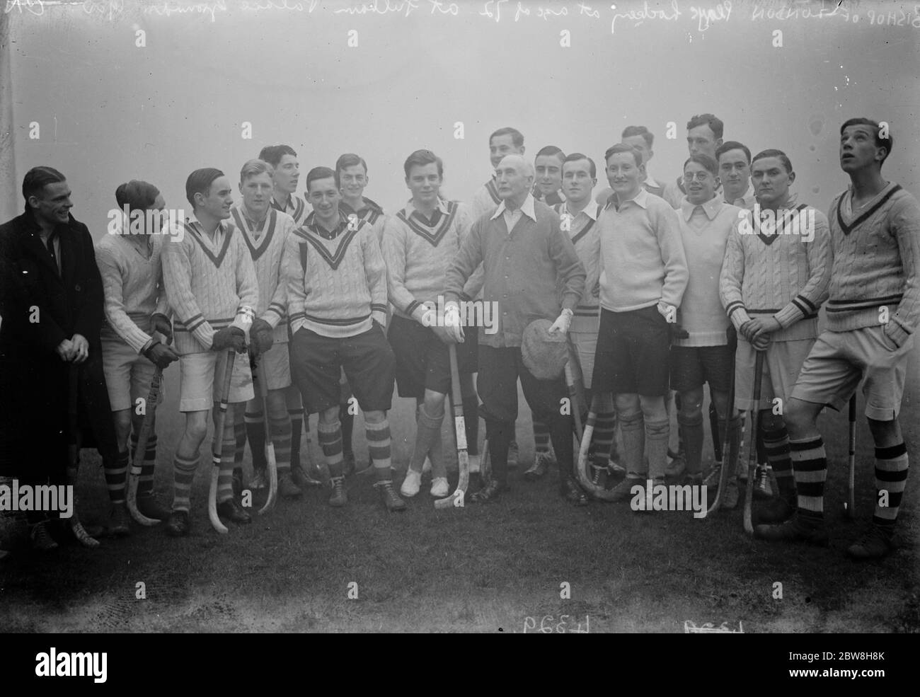 Bishop of London plays hockey at 72 , at Fulham Palace Grounds . The Bishop with the two teams . 22 December 1930 Stock Photo