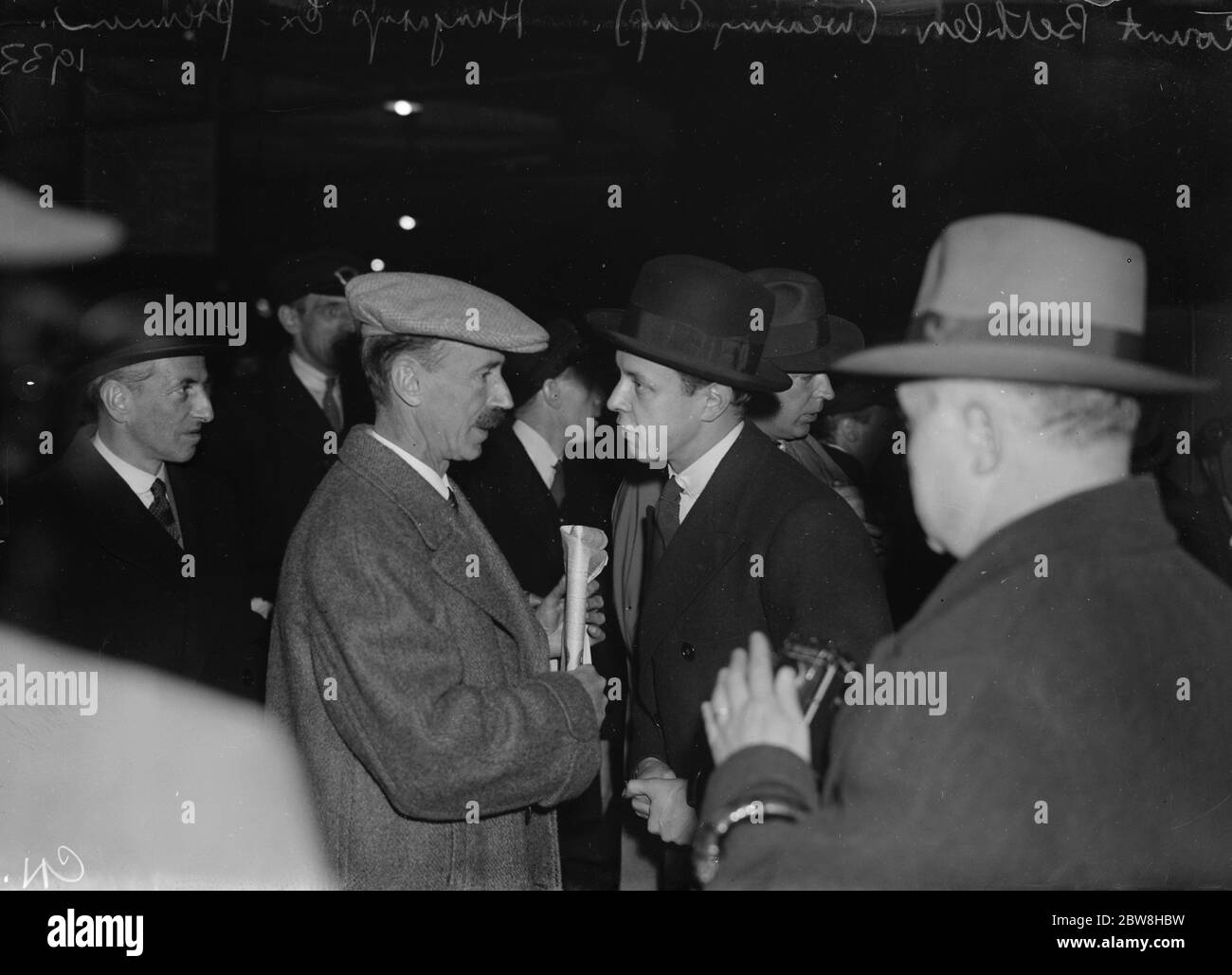 Hungary 's ex Premier arrives in London . Former Doyen of European Prime Ministers to Lecture . Count Bethlen ( wearing cap ) chatting with a member of the Hungarian Legation on arrival at Victoria . 18 November 1933 Stock Photo