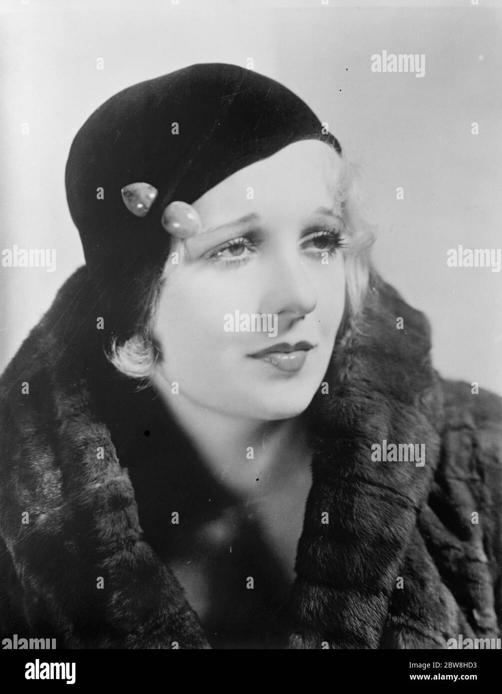 A charming hat that ' s popular this season . The brimless hat , Miss Anita Page , the film actress , wears . 14 August 1931 Stock Photo