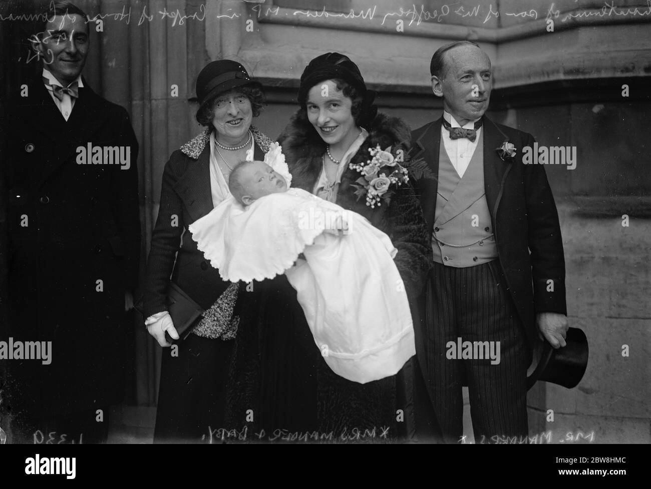Society christening in the crypt of the House of Commons . The infant son of Mr Geoffrey Mander , Liberal MP for Wolverhampton East was christened in the Crypt of the House of Commons . The parents with the baby and the baby ' s Grandmother . 3 November 1932 Stock Photo