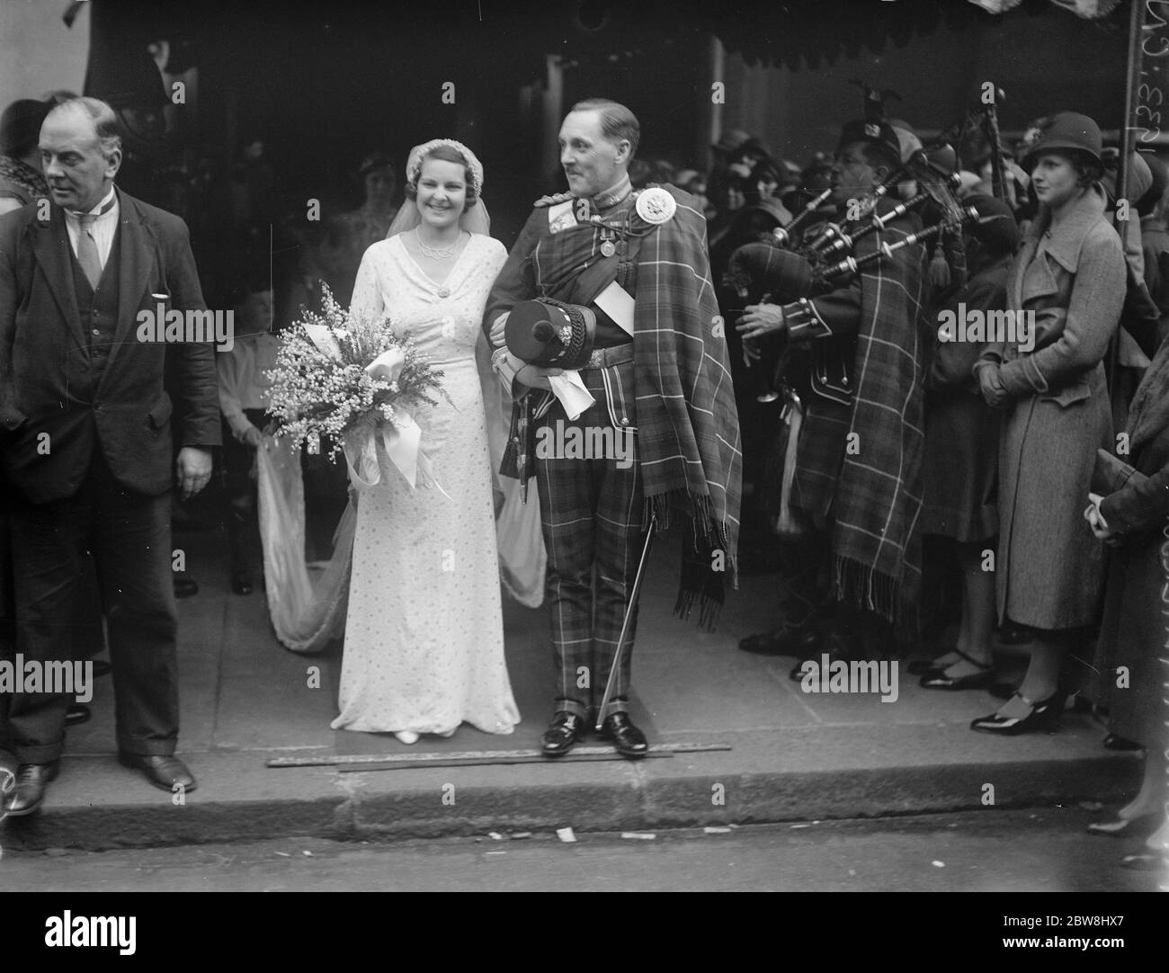 HIghland officer ' s wedding . The wedding of Captain J W M Paterson , H L I and Miss Brenda Roberst at Holy Trinity , Sloane Street . Bride and bridegroom . 21 October 1933 Stock Photo