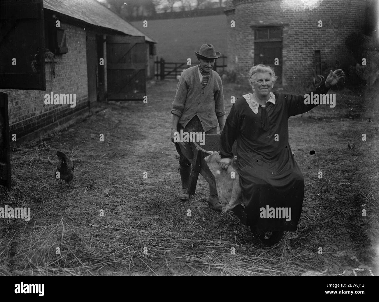 Thomas Couchman , champion ploughman in the farmyard with his wife