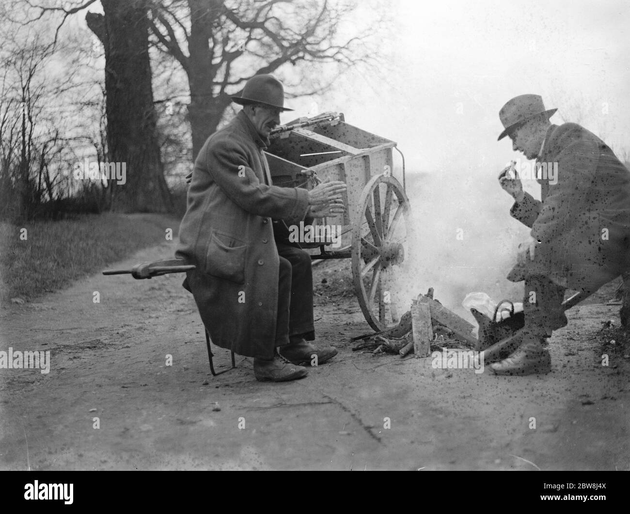 Road sweepers lunching round fire Chislehurst . 1935 Stock Photo