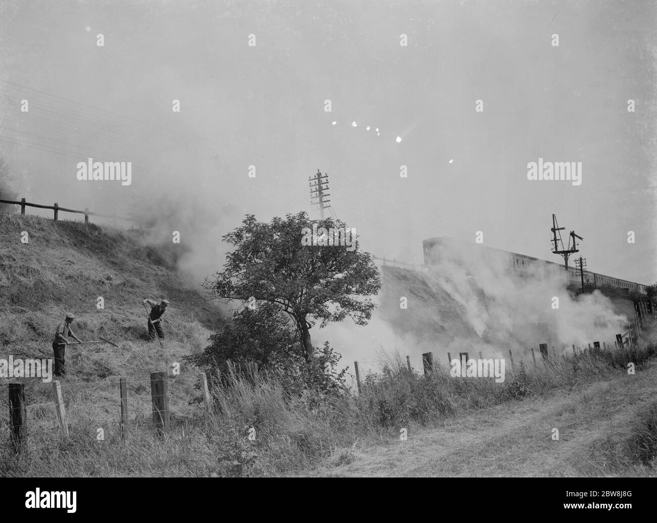 Burning grass on railway banks , Slades Green . 1937 Stock Photo