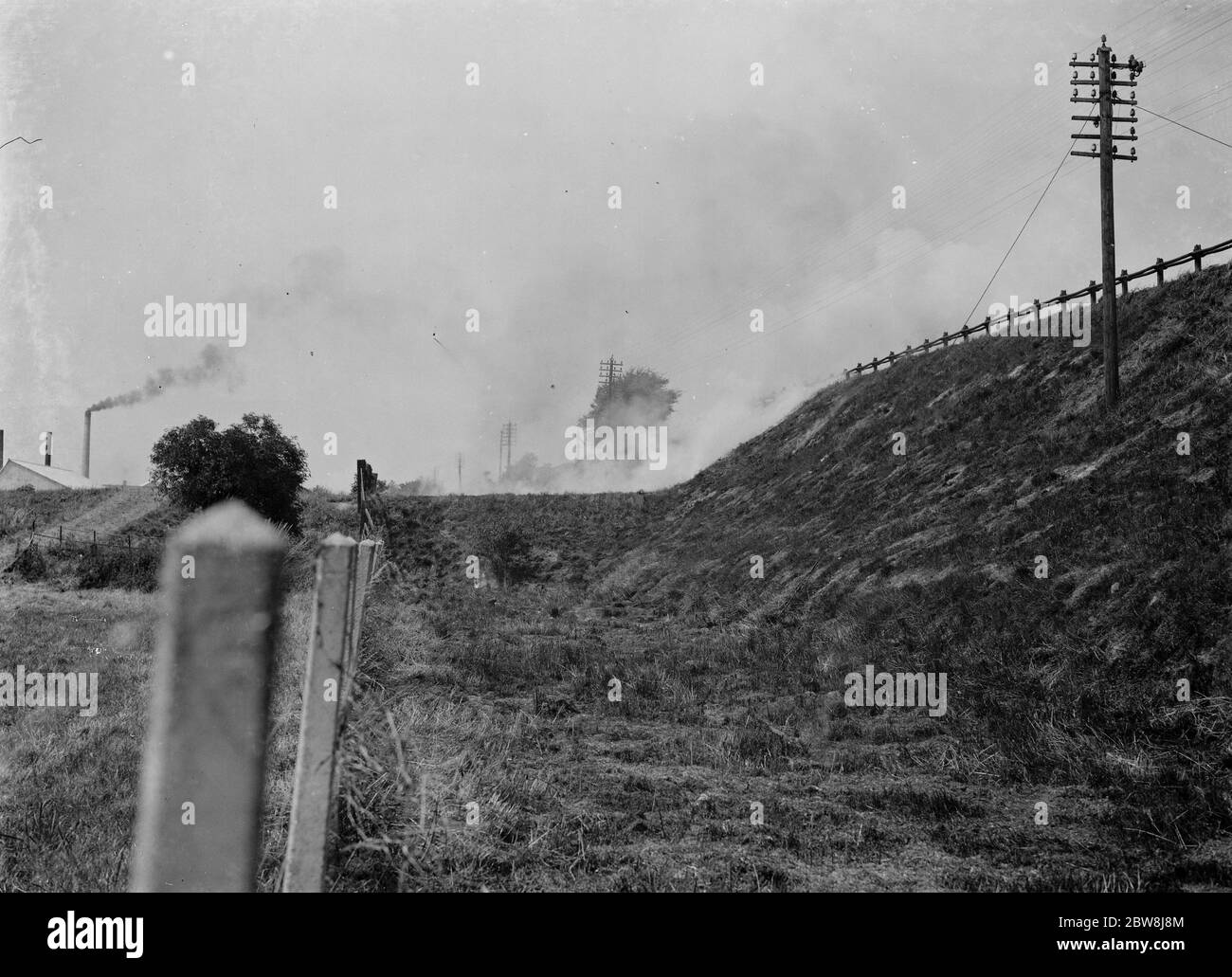 Burning grass on railway banks , Slades Green . 1937 Stock Photo