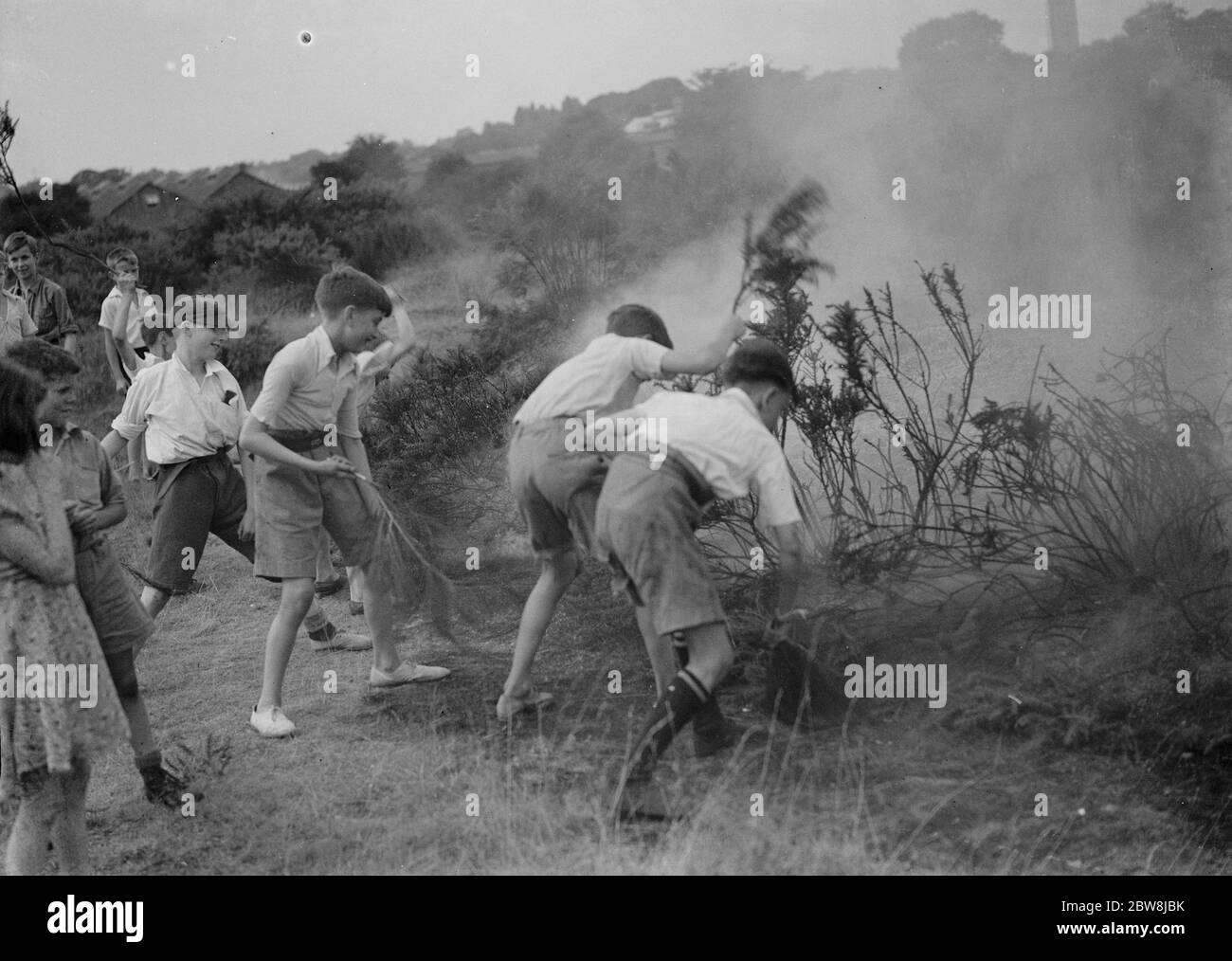 Children putting out fire , Dartford Heath . 1937 Stock Photo