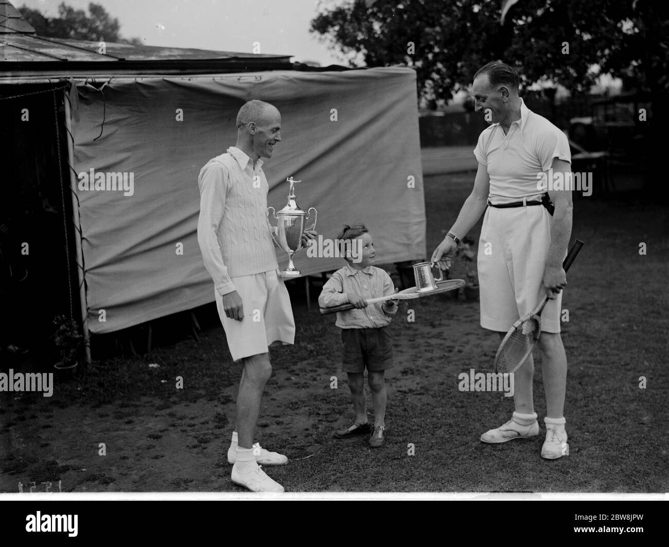 Tennis finalist at Bromley being handed their trophies by a child. 1935 . Stock Photo
