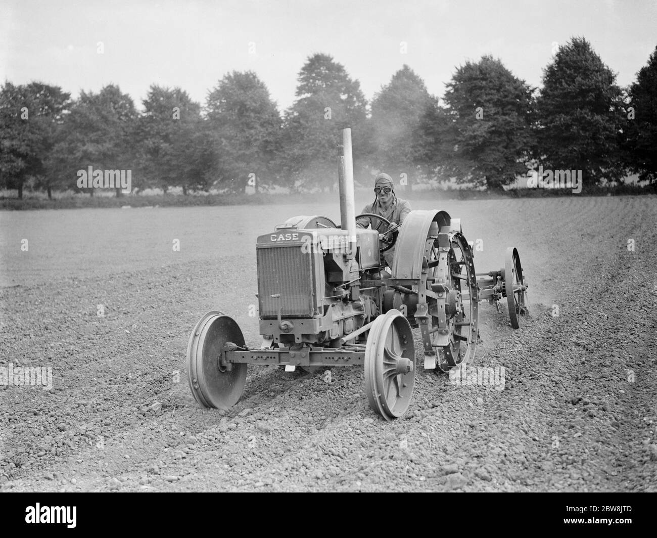 Tractor , driver wearing helmet and goggles . 1937 Stock Photo