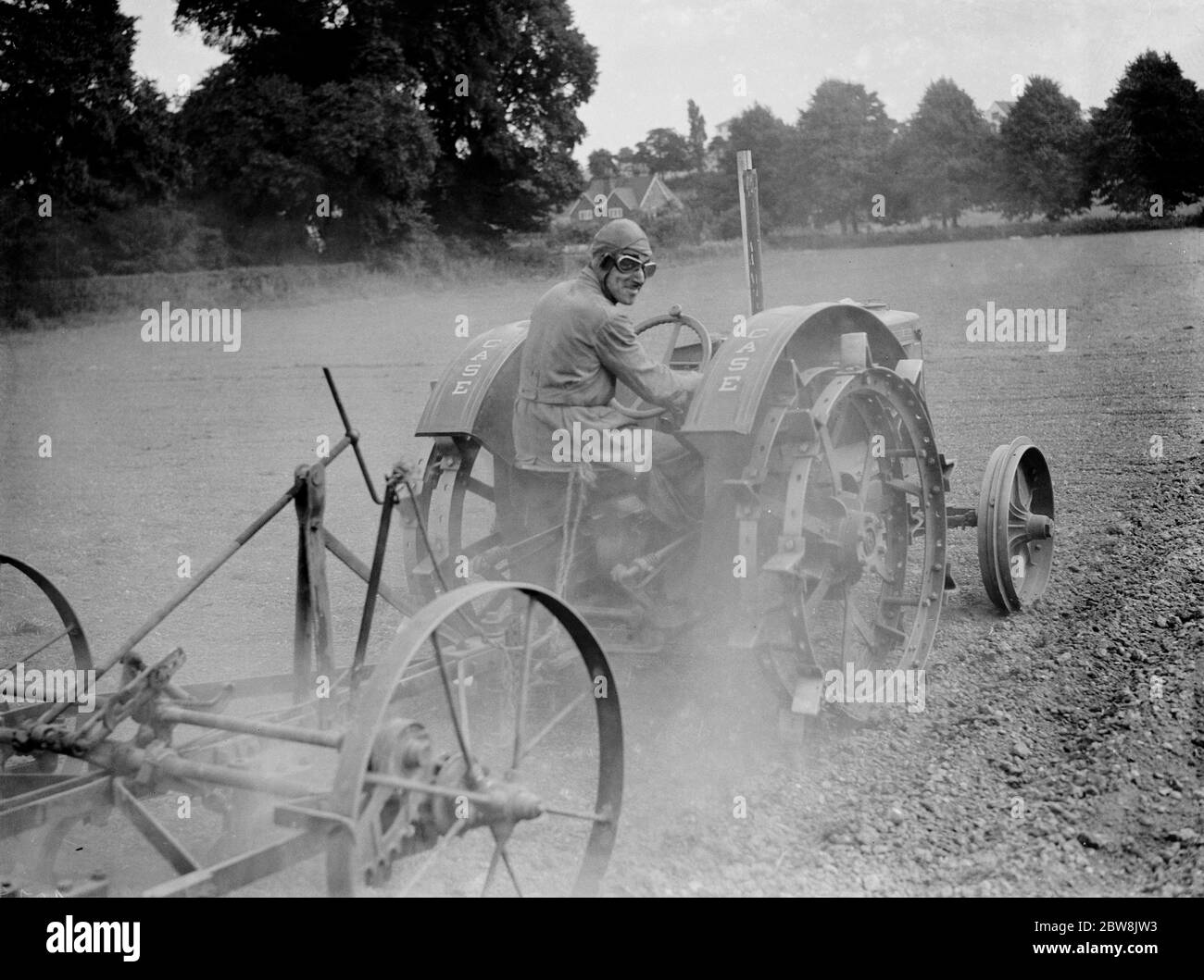 Tractor , driver wearing helmet and goggles . 1937 Stock Photo