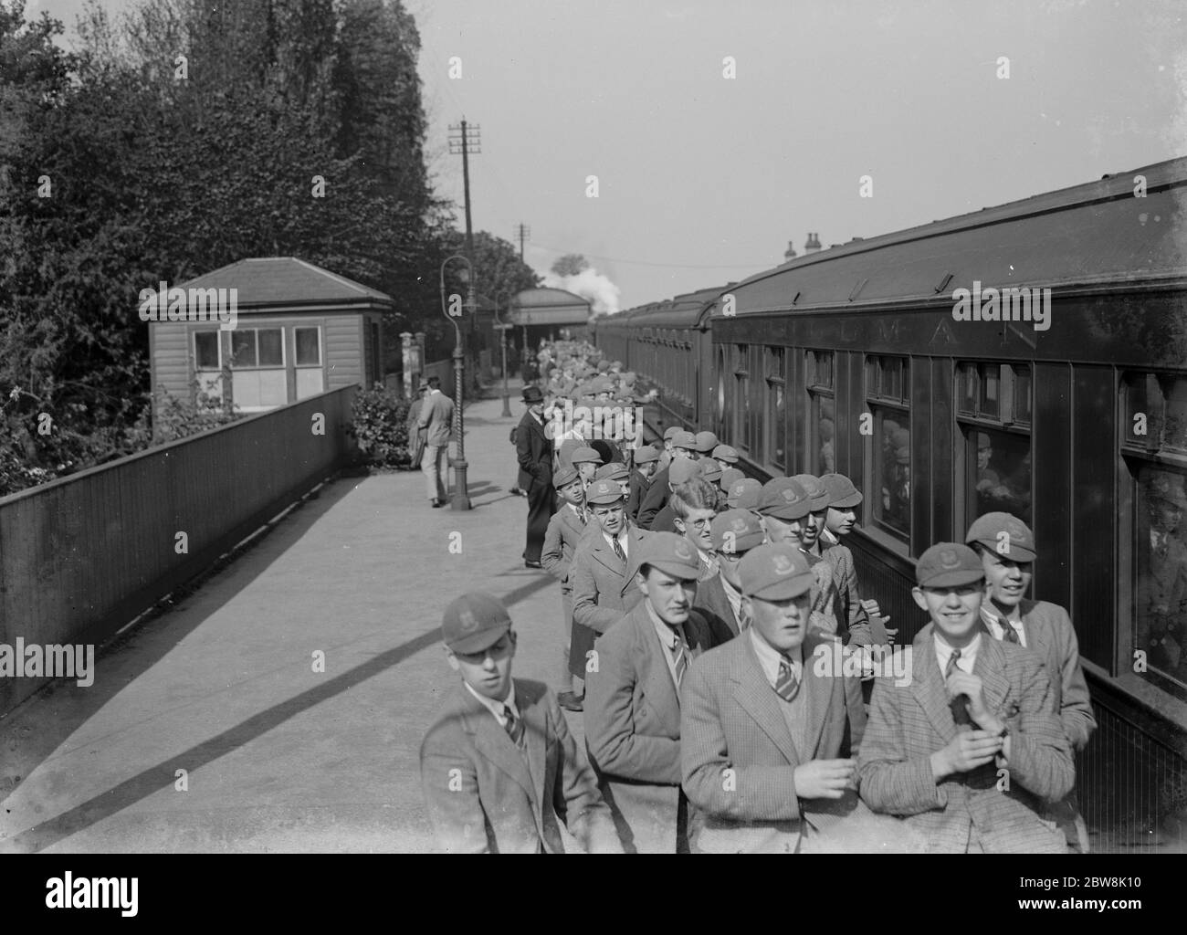 Schoolboys on the railway platform on their way to school . 1935 . Stock Photo