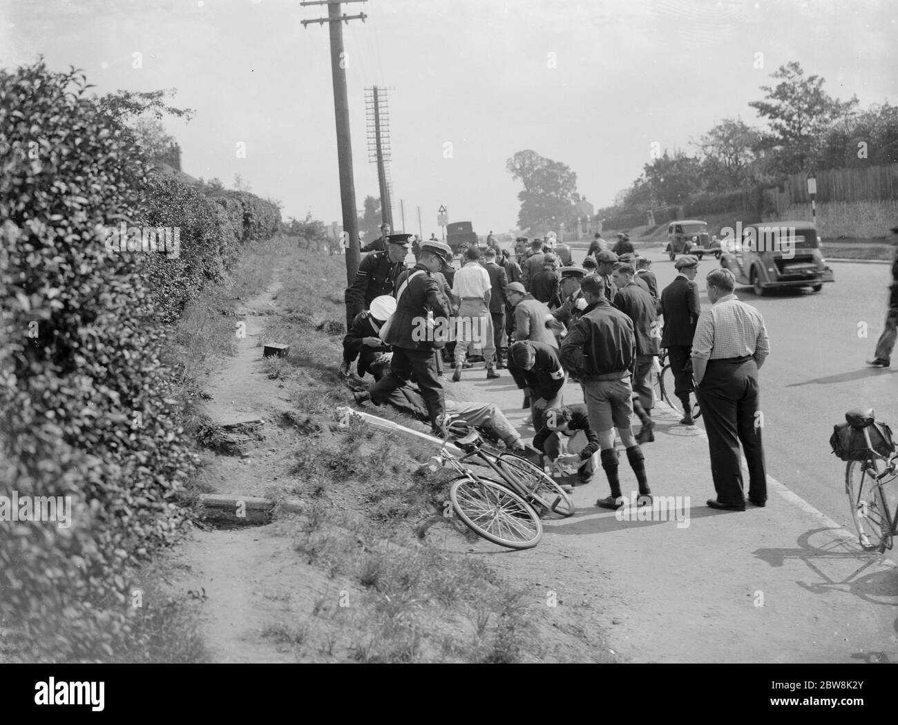 St John Ambulancemen giving aid to a casualty at the scene of a road accident . 1935 . Stock Photo