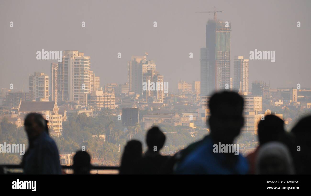 Silhouette of people in Mumbai on the background of the city skyscrapers. Stock Photo