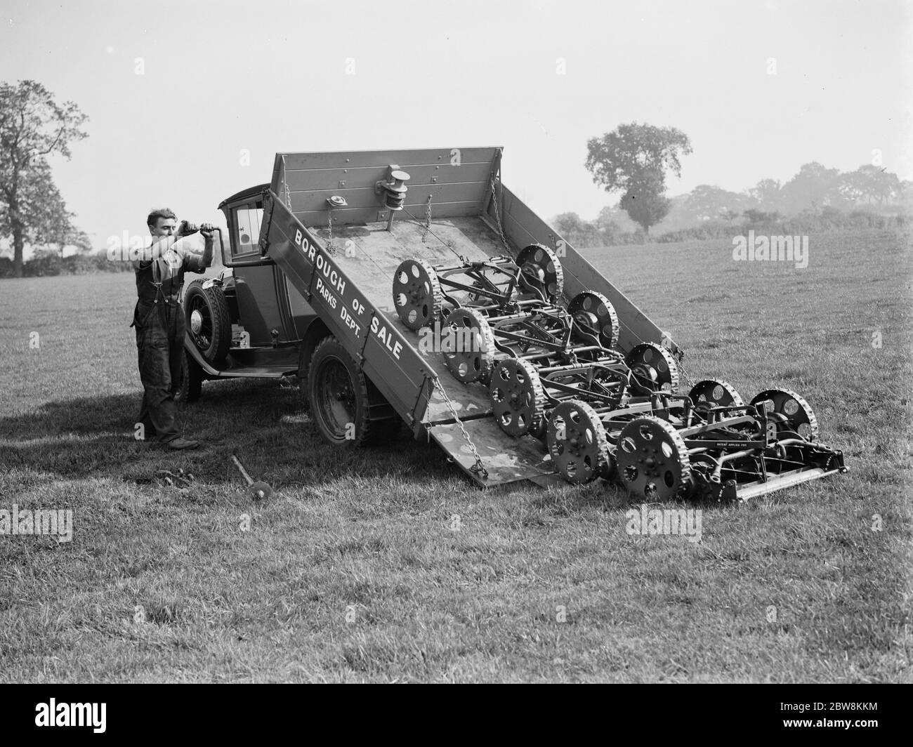 Unloading lawn mowers from the back of a council lorry from the parks department . September 1937 Stock Photo