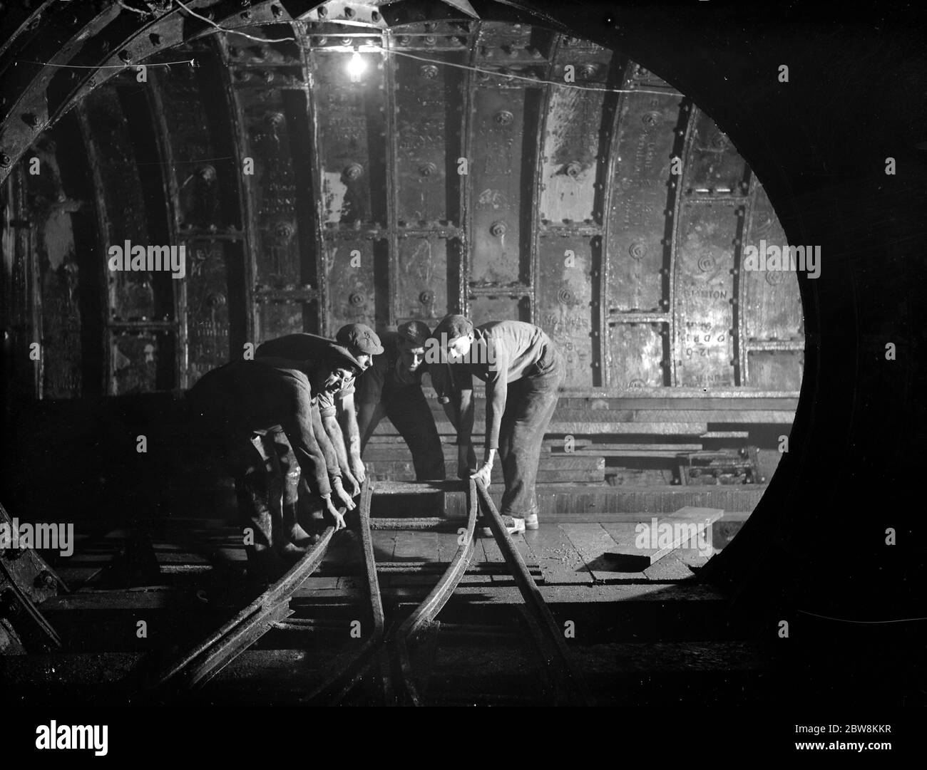 The Dartford tunnel men working the pipes . 1938 Stock Photo