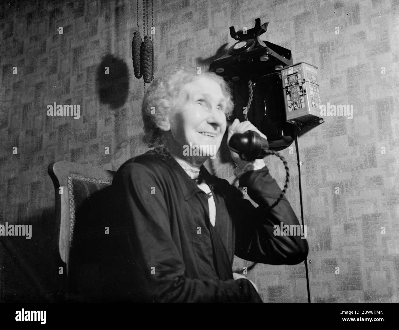 Granny Burton catching up on the telephone . 1938 Stock Photo