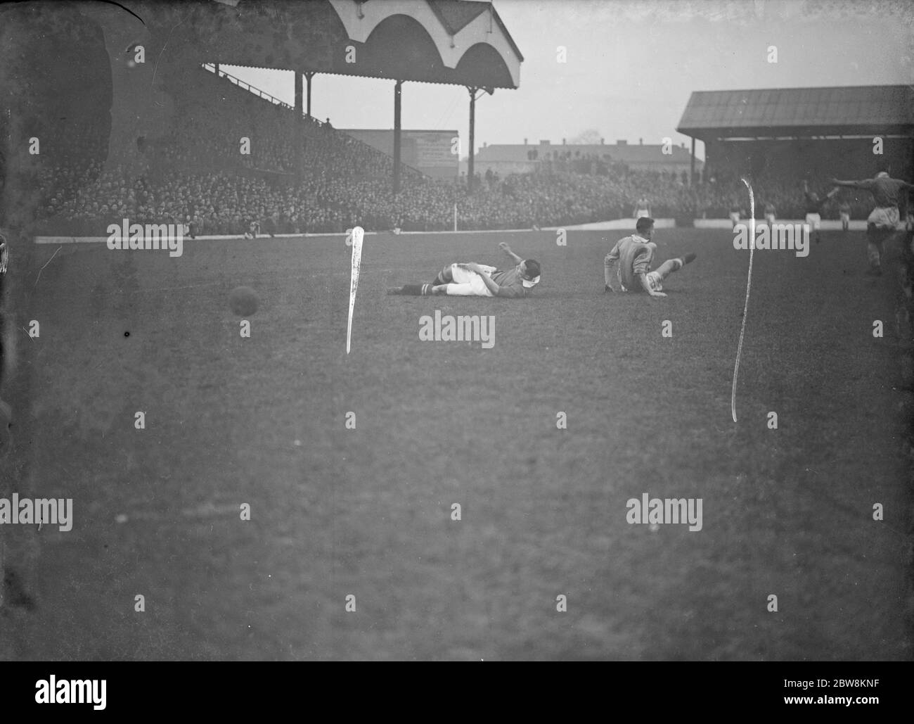 Charlton Athletic football club versus Birmingham City football club . Two players on the floor with the ball past them . 29 January 1938 Stock Photo