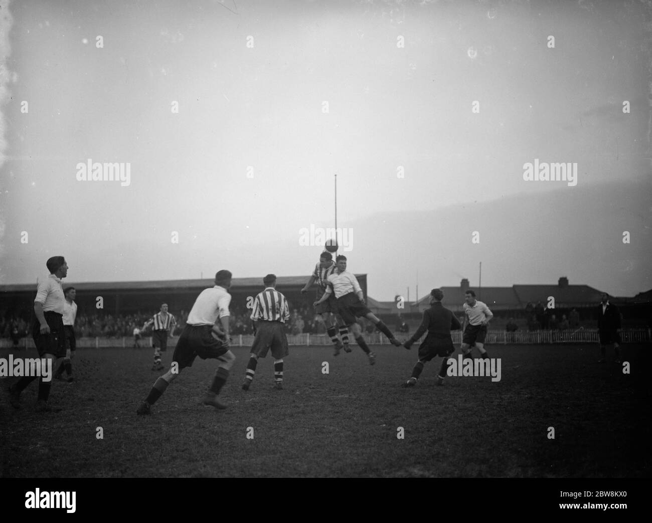 Dartford vs. Newport County reserves - Southern League - 12/12/37 Two players compete in the air . 12 December 1937 Stock Photo
