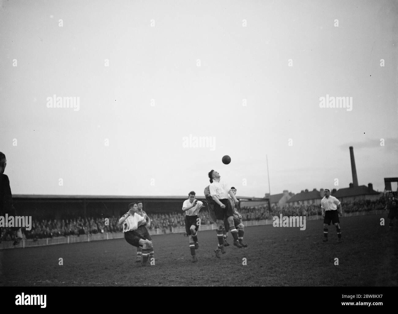 Dartford vs. Bournemouth and Boscombe Athletic - FA Cup 1st Round replay - 01/12/37 . Two players compete for the ball in the air . 1937 Stock Photo