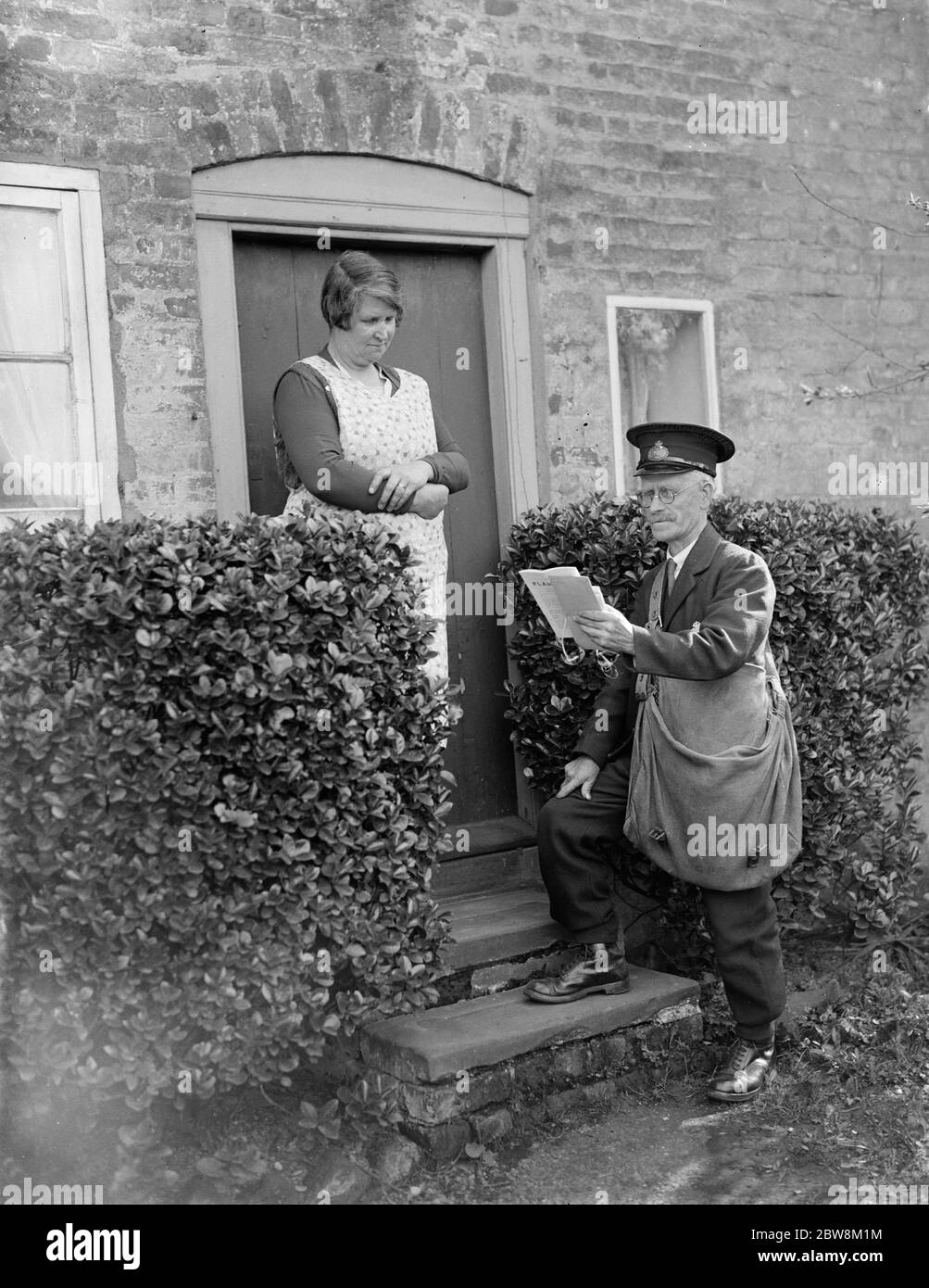 Postman delivering at a cottage . 1935 Stock Photo
