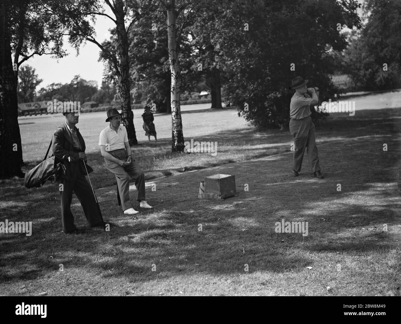 Golfers driving off the green . . 1935 Stock Photo
