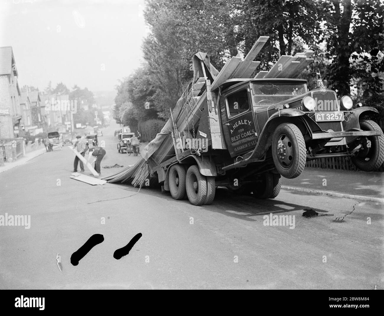A lorry tips backwards , spilling its load in Sevenoaks , Kent . 1935 . Stock Photo