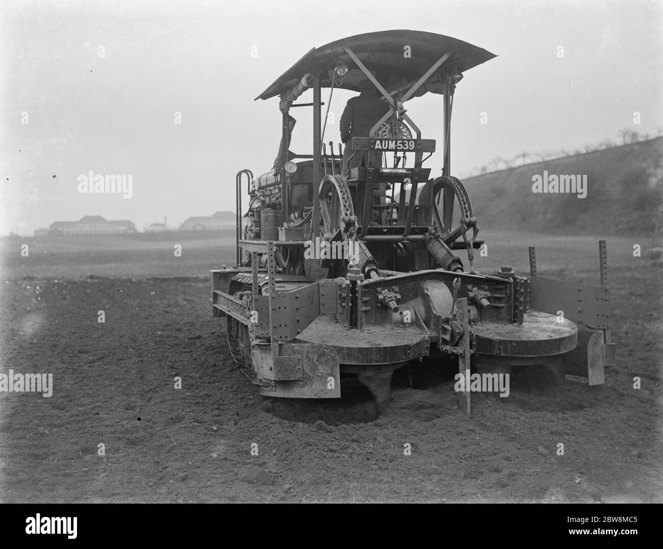 A Gyrotiller ( diesel rotary plough ) at work in a field . 1935 Stock Photo