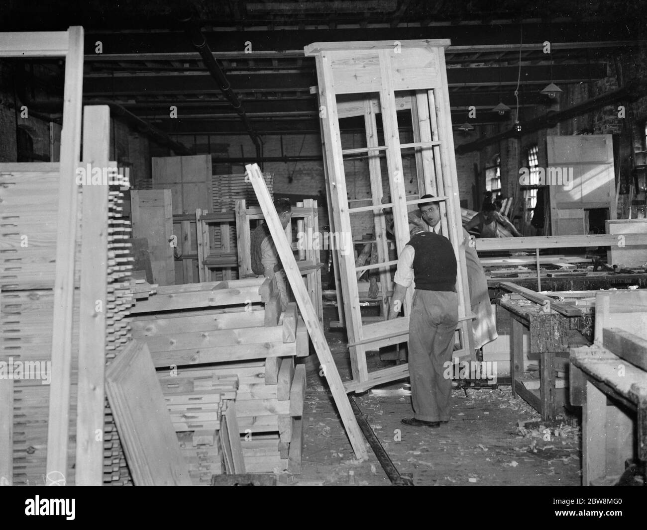 A pair of joiners works on a piece at the G Ellis joinery works in