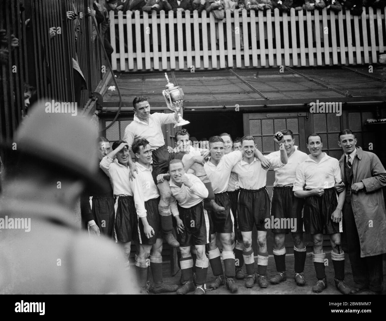 Bromley football club versus Belvedere football club in the FA Amateur Cup Final at Millwall football club stadium the The Den in South Bermondsey, London . Bromley the winning team hold the cup aloft . 1938 Stock Photo