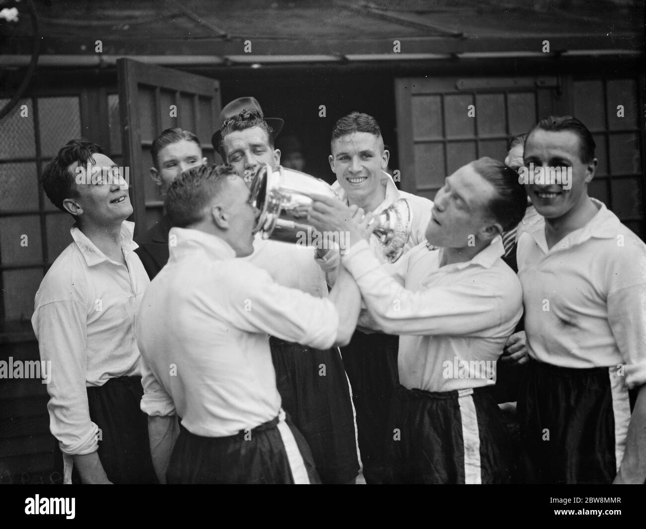 Bromley football club versus Belvedere football club in the FA Amateur Cup Final at Millwall football club stadium the The Den in South Bermondsey, London . Bromley the winning team hold the cup aloft . 1938 Stock Photo