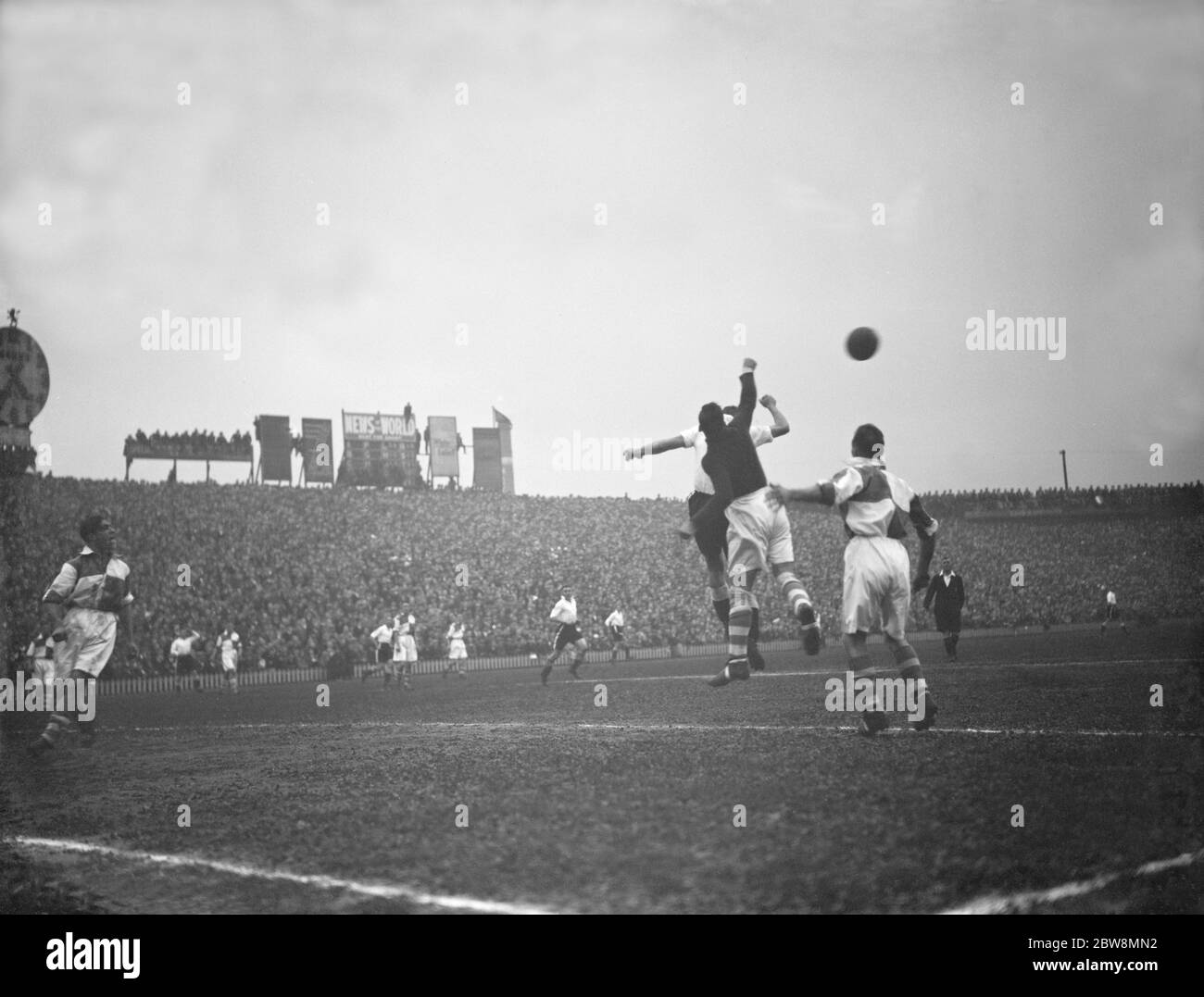 Bromley vs. Erith and Belvedere - FA Amateur Cup final - Erith and Belvedere's goalkeeper Albert Gibbs punches clear - 23/04/38 at Millwall football club stadium the The Den in South Bermondsey, London . Two players compete for the ball . 1938 Stock Photo