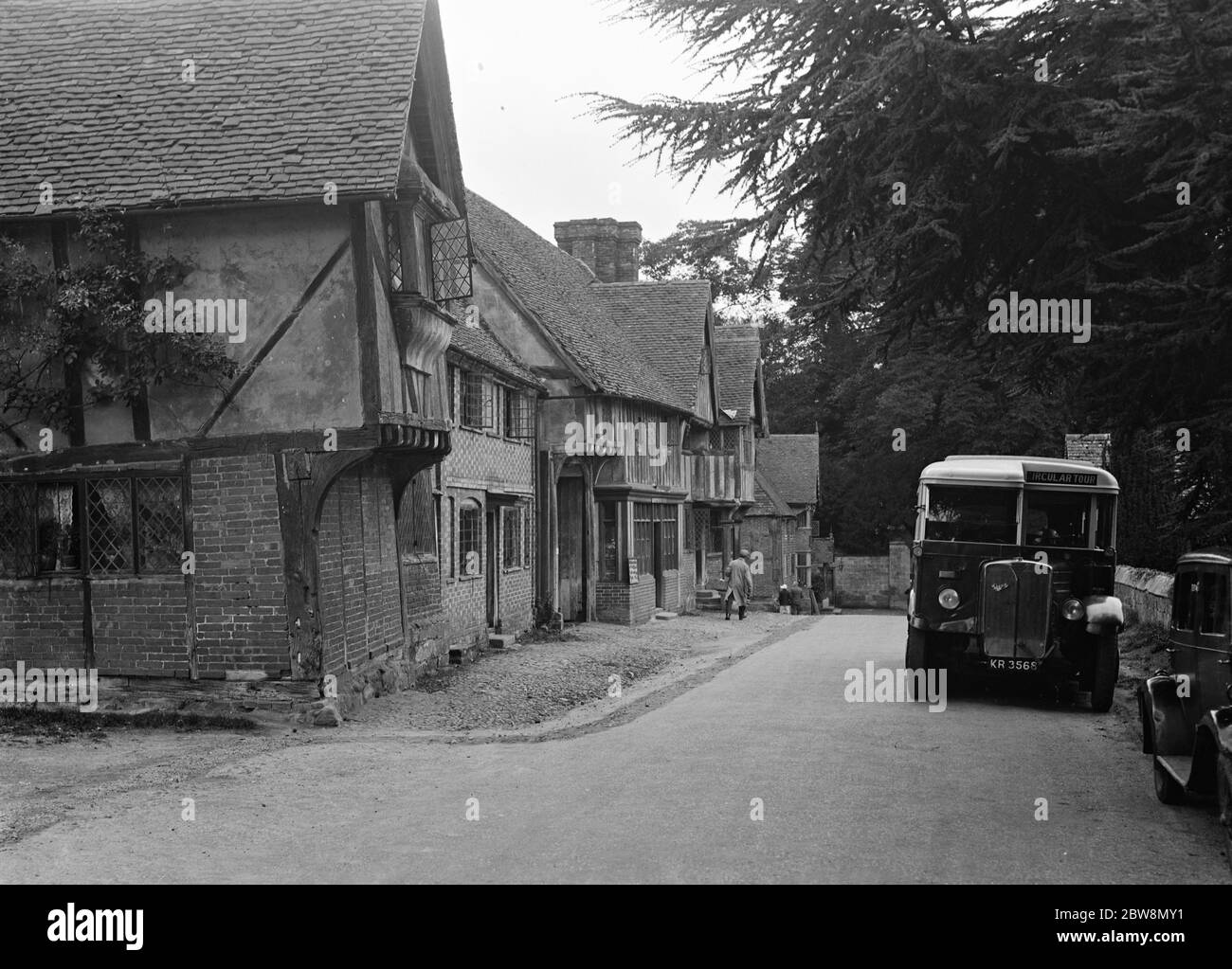 A bus in the village of Chiddingstone , Kent , showing the old cottages . 1935 Stock Photo
