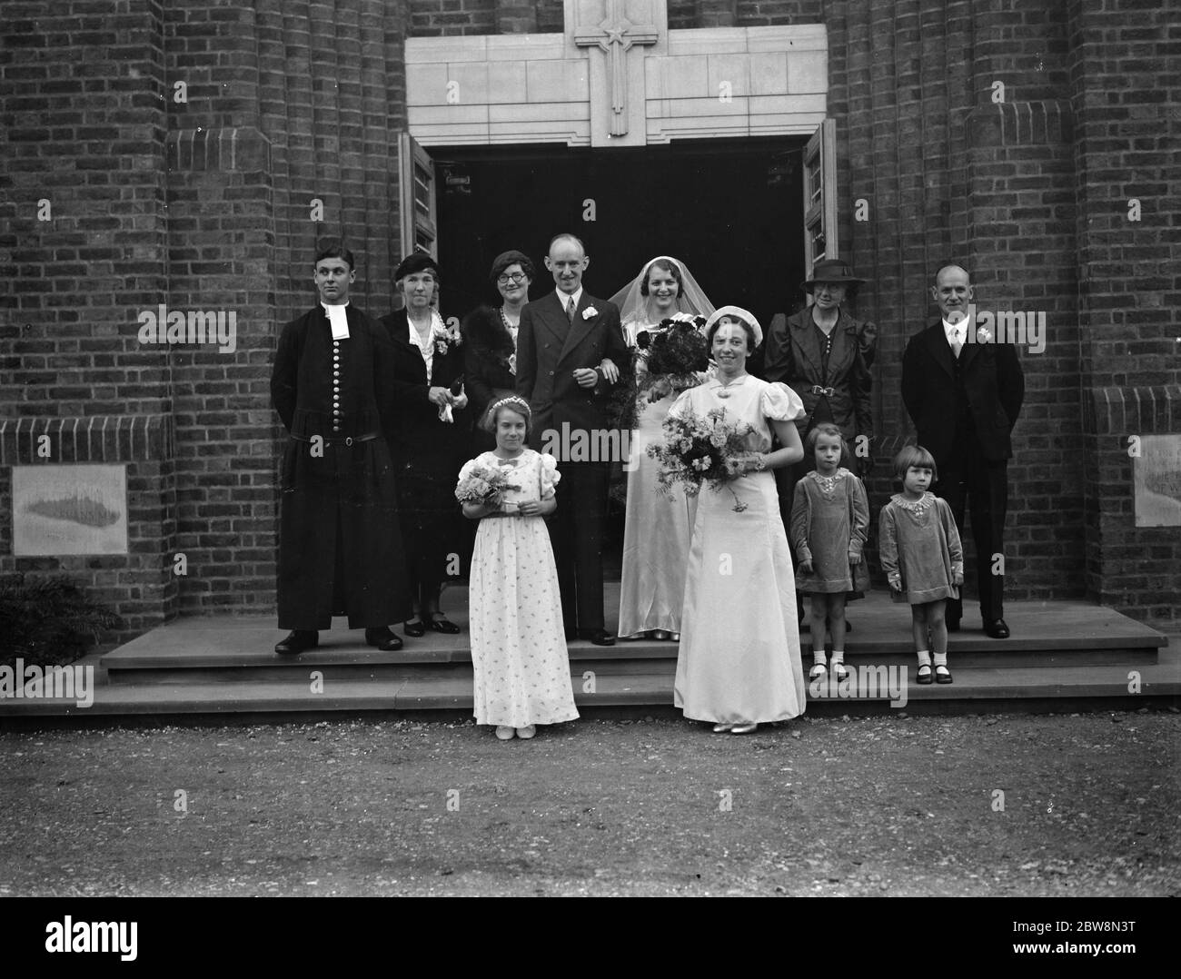 The wedding of J Houlgate and D Wonersley . Bride and Bridegroom with the bridesmaids and the wedding party . 30 October 1937. Stock Photo