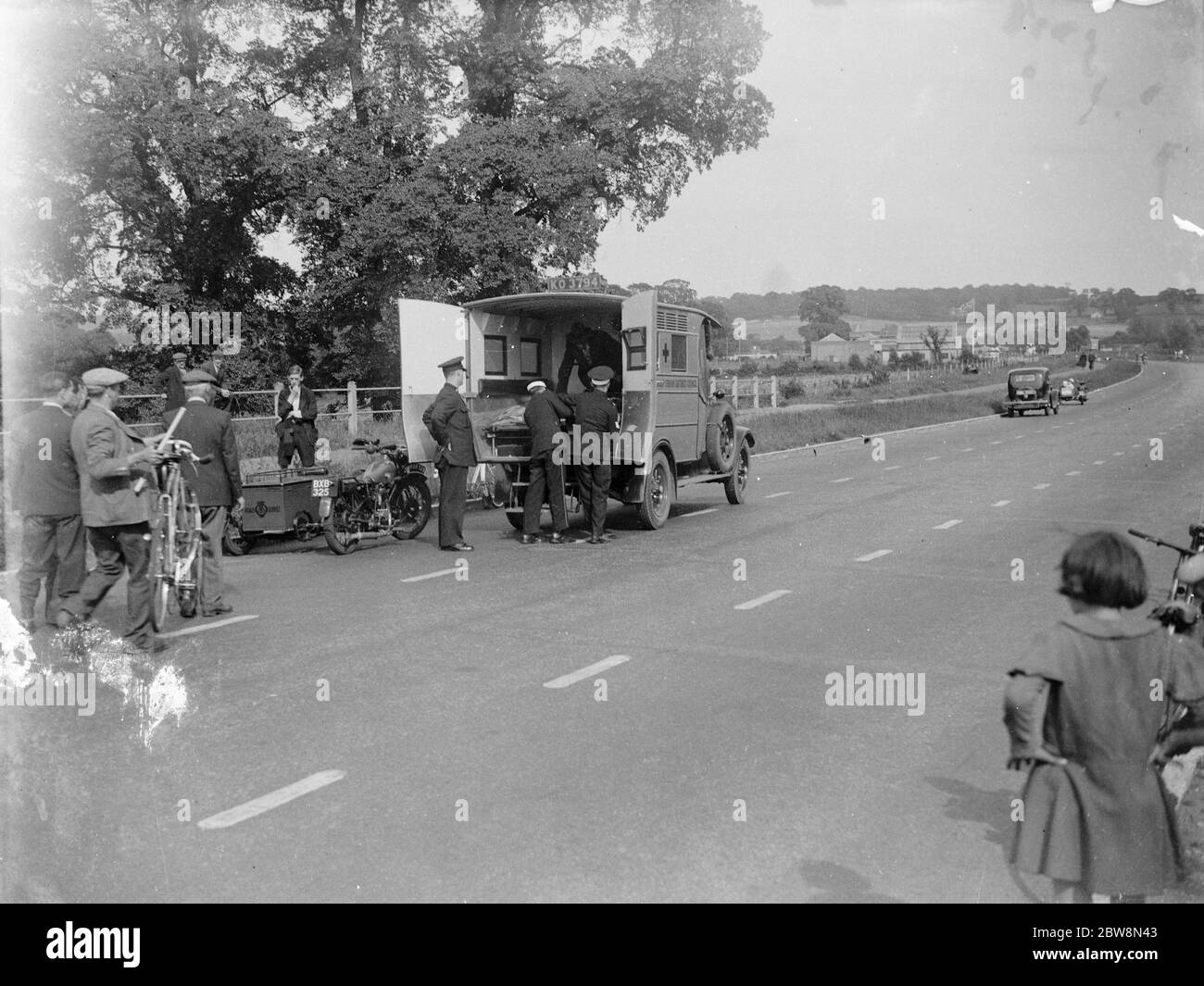 Loading a casualty of a road accident into an ambulance . 1935 Stock