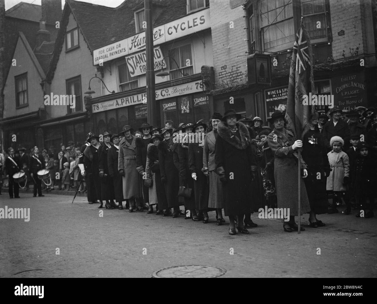 The women of the Royal British Legion wait with their flag for the procession to start at the Dartford Armistice memorial service . 1937 Stock Photo