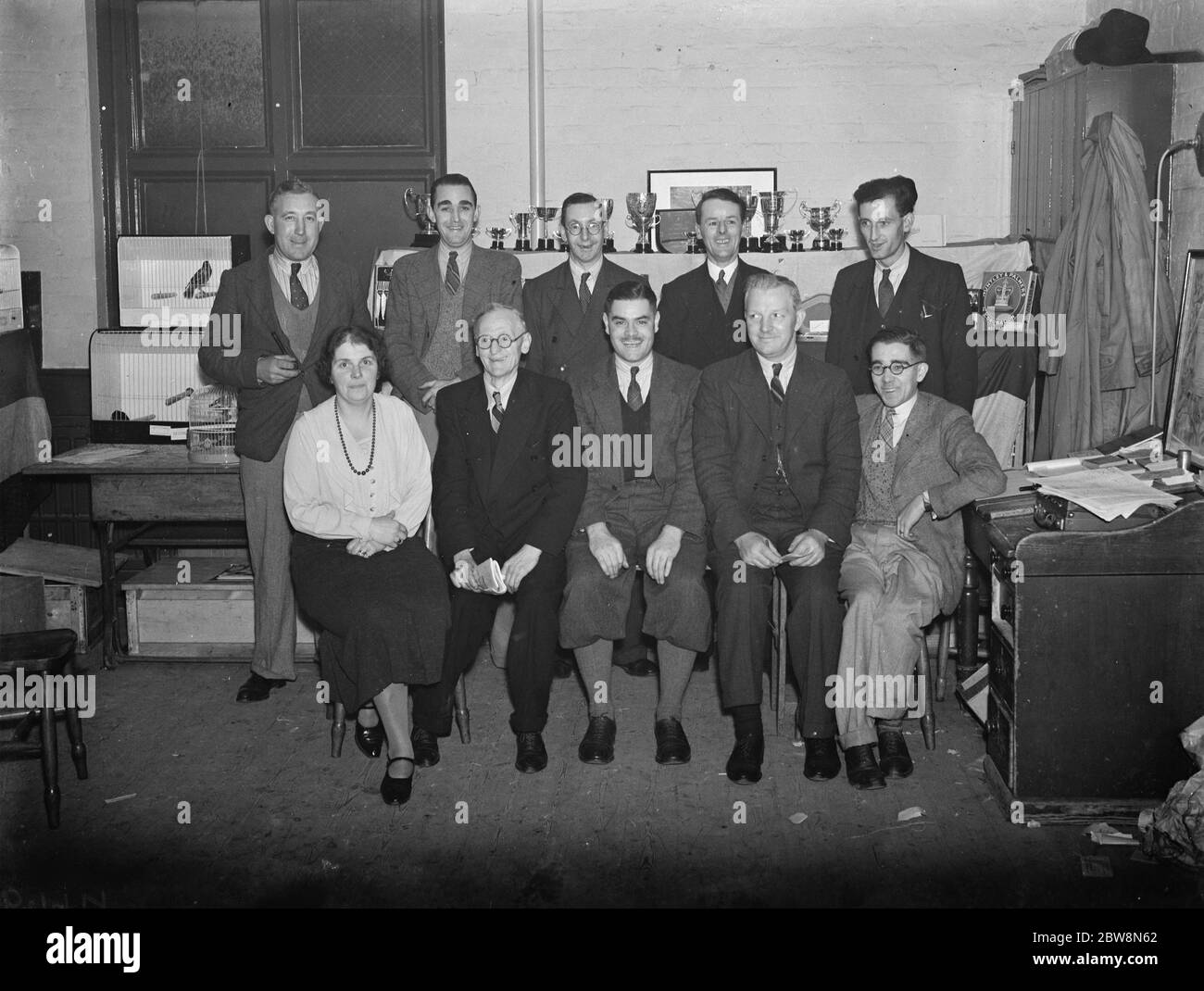 Sidcup Cage Bird Association Show . Club officials , front row , left to right ; Mrs Thornton , Mr A Goodwin ( Judge ) , Mr F C Jones ( Chairman ) , Mr Ephgrave ( Judge ) Mr Kirby Smith ( Secretary ) Standing , left to right ; Mr B Proudfoot , Mr E Watkins , Mr S Rice , Mr S Cayless , Mr J Slade . 1937 Stock Photo