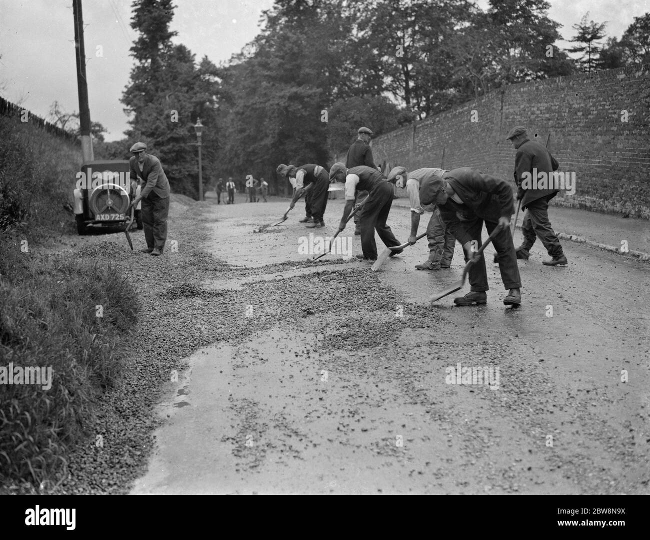 Men work on the North Cray road , fixing the damaged surface . 1938 Stock Photo
