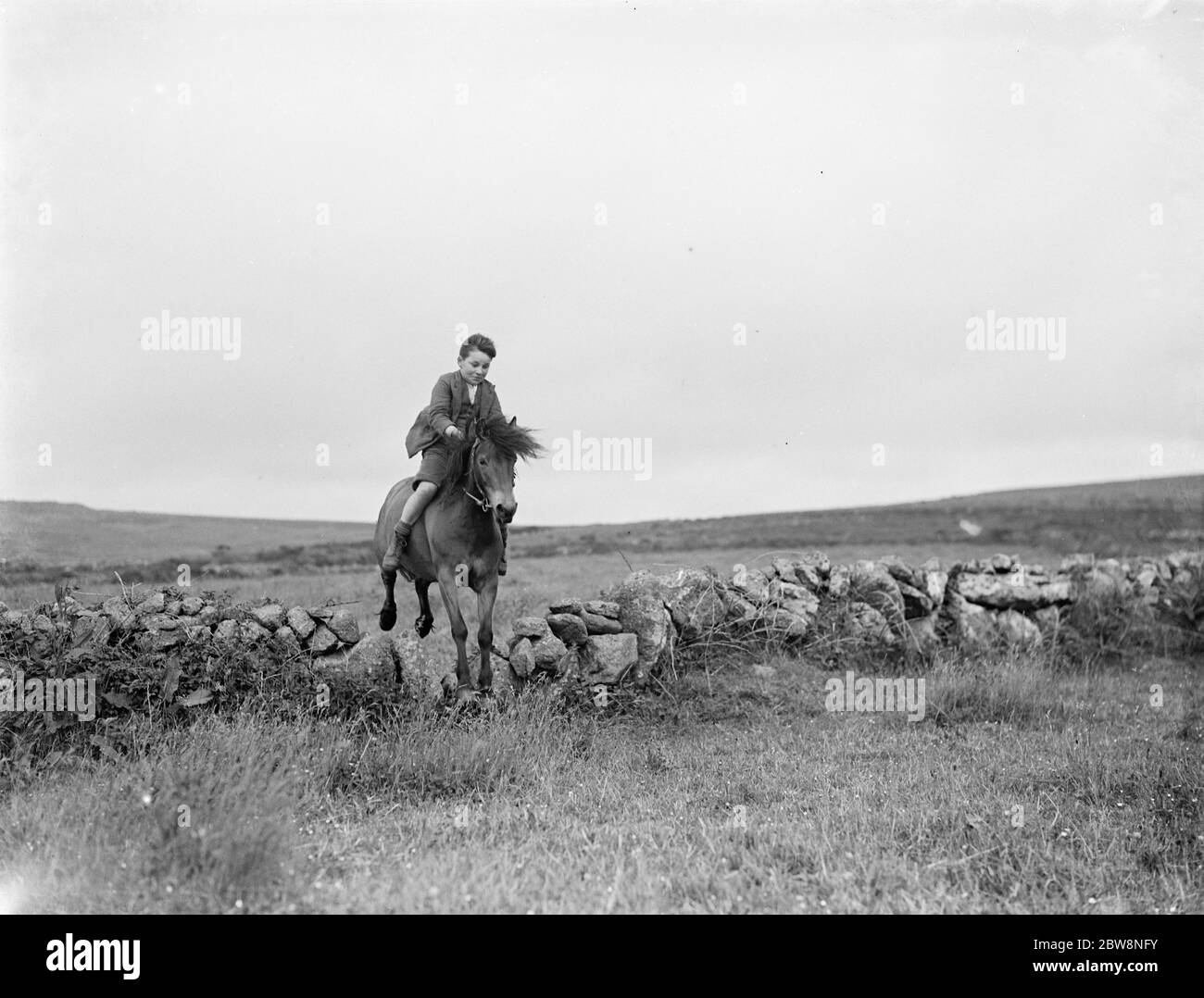 A young boy rides a horse bareback . 1936 . Stock Photo