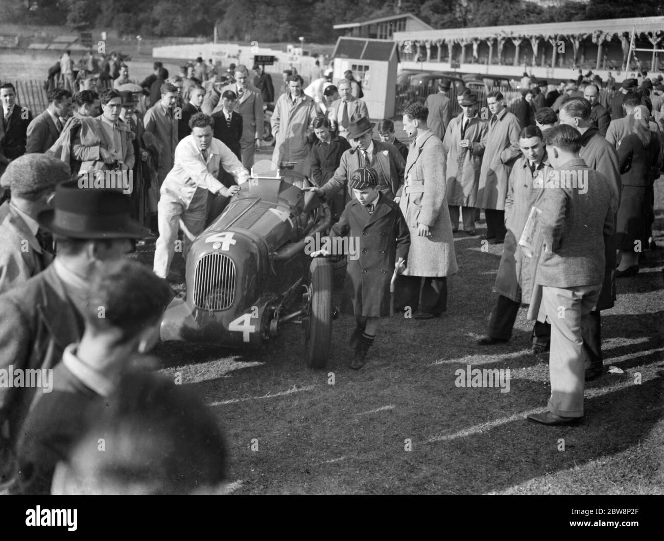 J H T Smiths M G is man handled through the crowd . 1938 Stock Photo