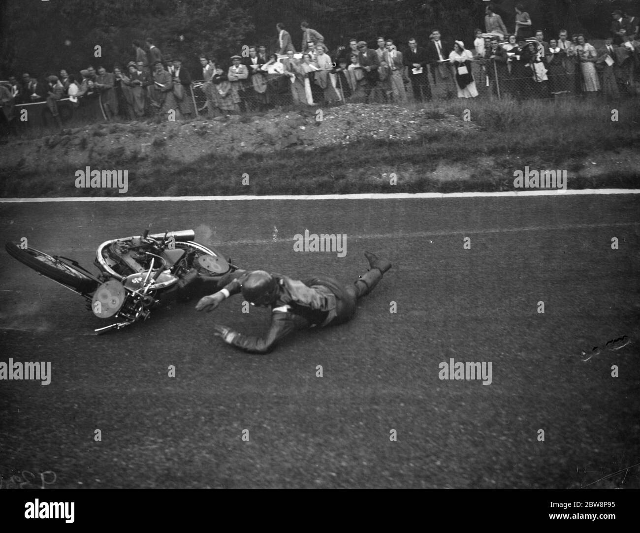Crystal Palace road racing . A R Fosters bike skids out from under him . 1938 Stock Photo