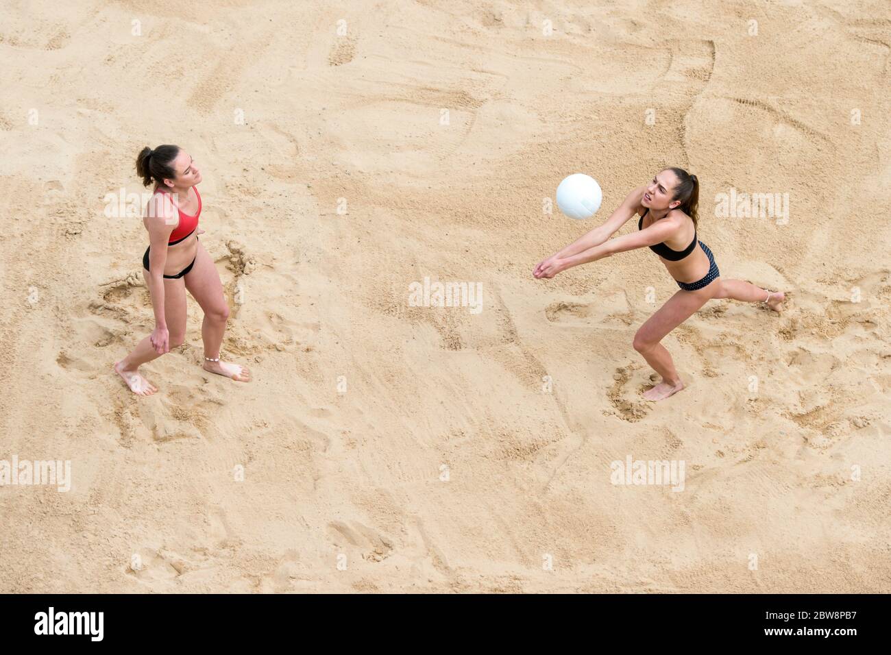 Athletes from beach volleyball in the fight for the ball. Summer vacation and sport concept Stock Photo